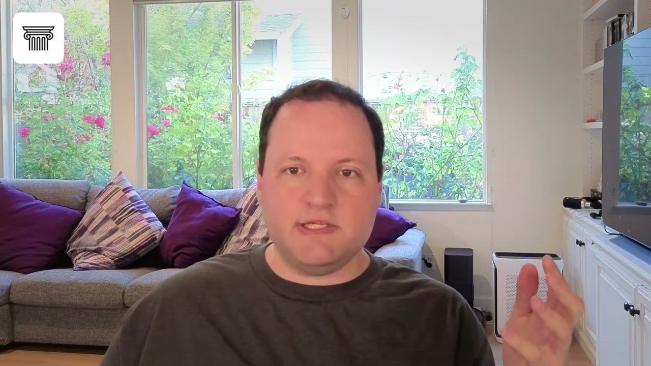 Man speaking to camera in a living room