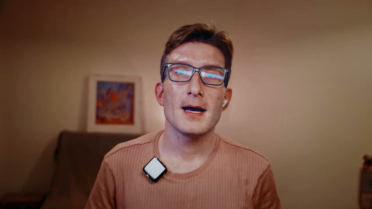 Man in glasses speaking to camera, video still
