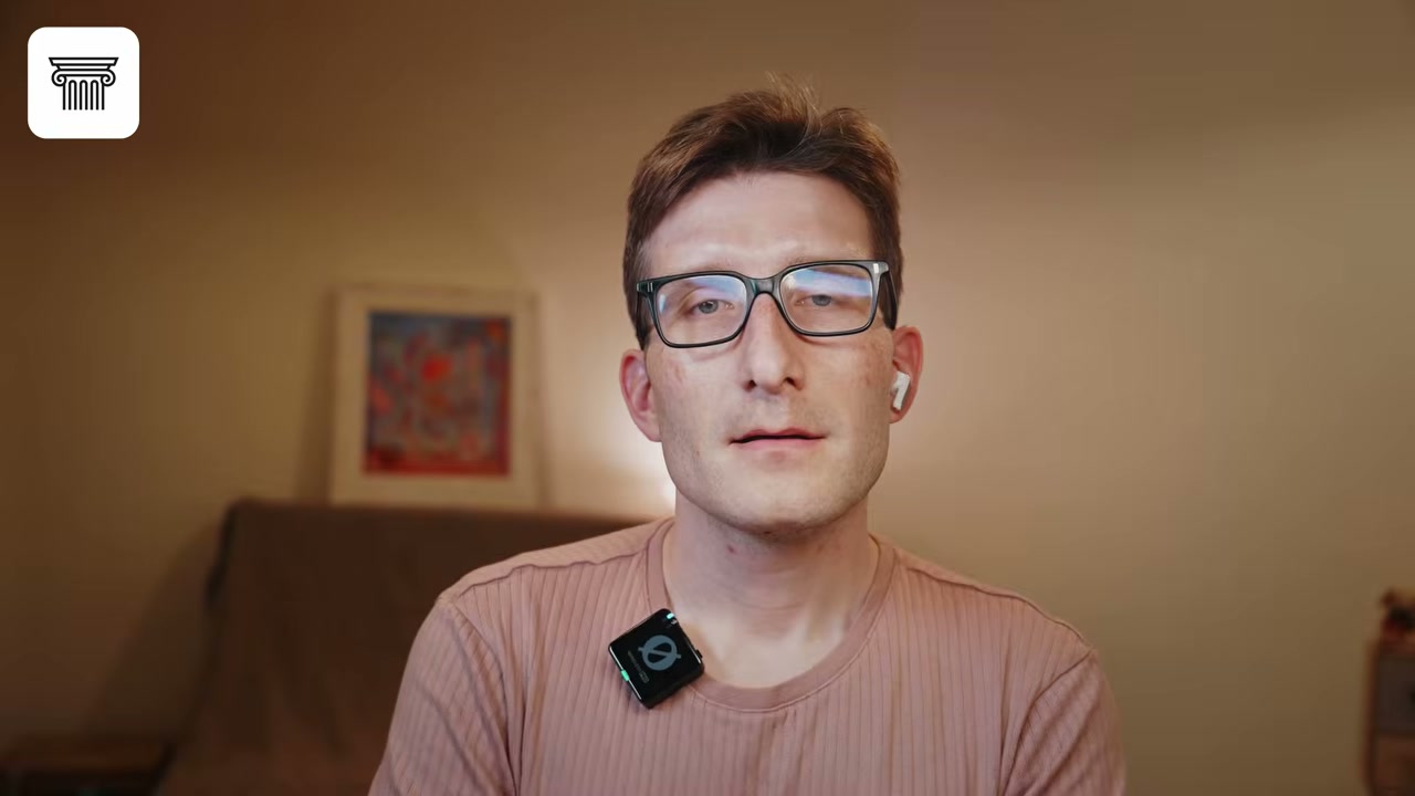 Man in glasses facing camera in warm room