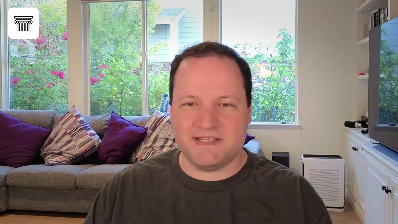Man speaking to camera in a living room