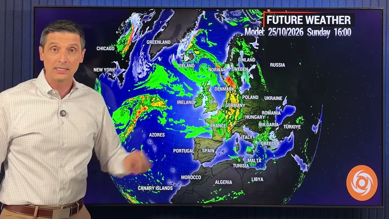 Weather presenter beside Europe and North Atlantic forecast map